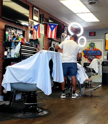 Barbers working on clients inside Faded Barber Shop in Rehoboth Beach