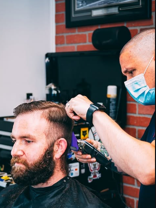 Barber blending a men's fade with clippers in Rehoboth Beach
